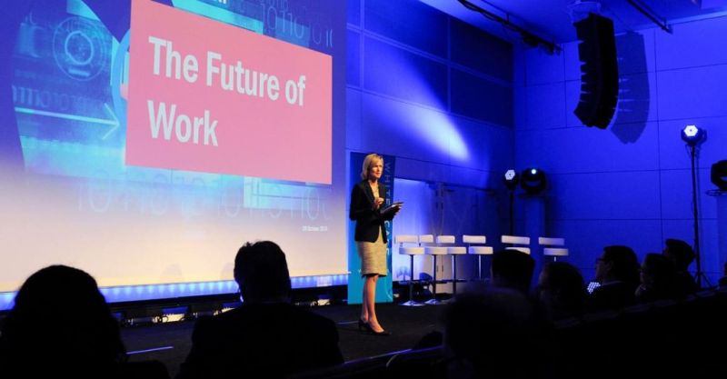 A keynote speaker addresses a large conference audience, illustrating the draw of prominent speakers for event marketing.